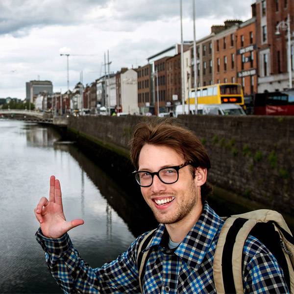 Study abroad student showing Anchor Up hand sign